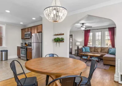 Elevated Retreat dining area with round table and chandelier