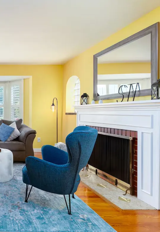 Living room with fireplace and blue armchair