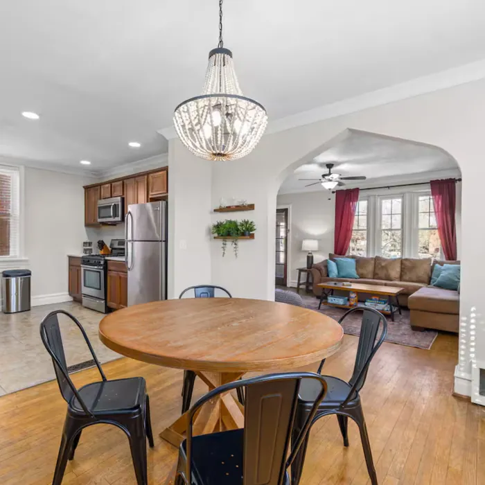 Elevated Retreat dining area with round table and chandelier
